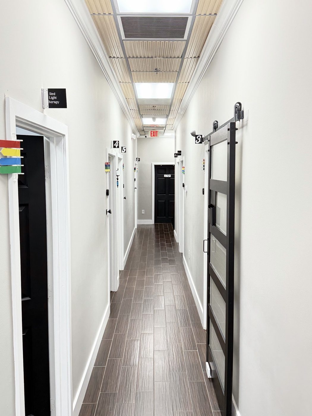 Parkland, FL Chiropractor | Dr. Jared Cohen | Coral Springs Chiropractor 9 Red light therapy and treatment room hallway at The Spine and Wellness Center, Coral Springs FL